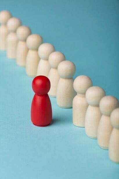 Business roles represented by various pawns, with a standout red pawn symbolizing individuality