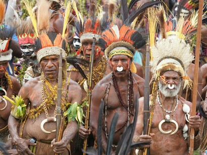 Tradition and identity shine through the colors, feathers, and ancestral regalia