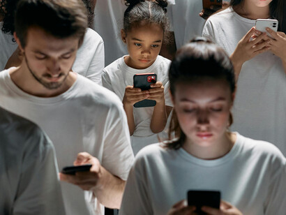 A group of people absorbed by their mobile phones
