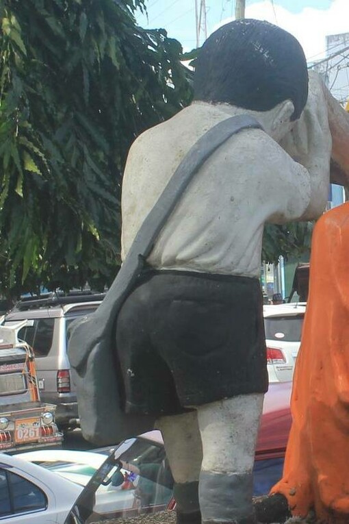 Statue of a child offering mano gesture in Iriga, Philippines