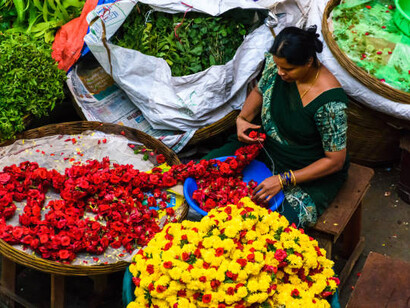 Flower vendors arrange fresh blooms at the busy KR Market in Bangalore, India