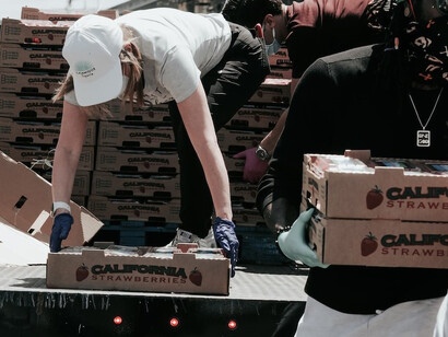 A dedicated female volunteer unloading a truck full of food for those in need