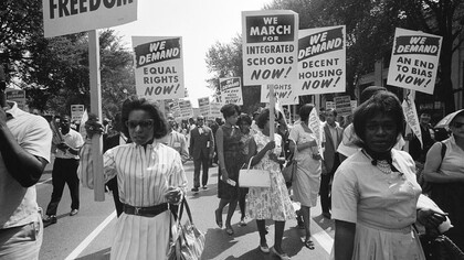Washington, D.C. August 28, 1963, The civil rights march on Washington with a procession of African Americans carrying signs for equal rights and integrated schools
