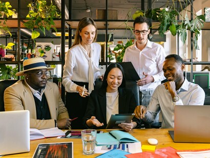 A multicultural group united in the workplace, reflecting how immigration strengthens productivity and collaboration