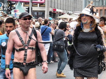 Man in S&M outfit being led