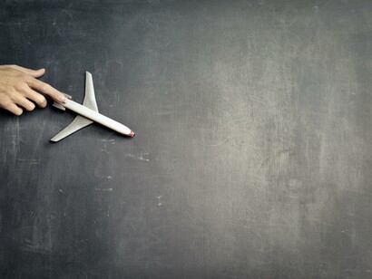 A plastic airplane on a chalk board 