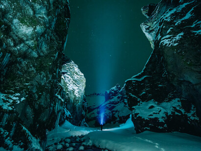 Rocky terrain lit up in the dark, a portrayal of how energy makes matter more beautiful