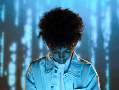 Illustration of AI speed with a teenage boy in front of a glowing digital background