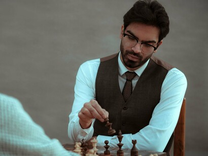 A professional carefully making the next move, representing the power of thoughtful strategy over impulsive action
