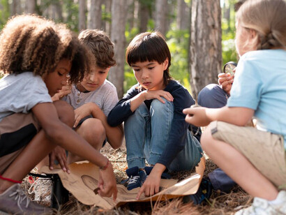 Kids involved in a treasure hunt experience hands-on exploration and problem-solving activities, enhancing their learning and encouraging brain development through imaginative play