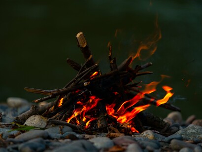 A crackling fire glowing in the wilderness, symbolising the process of learning through experience