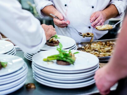 A chef prepares dishes during a busy service in a fine dining kitchen in São Paulo, Brazil