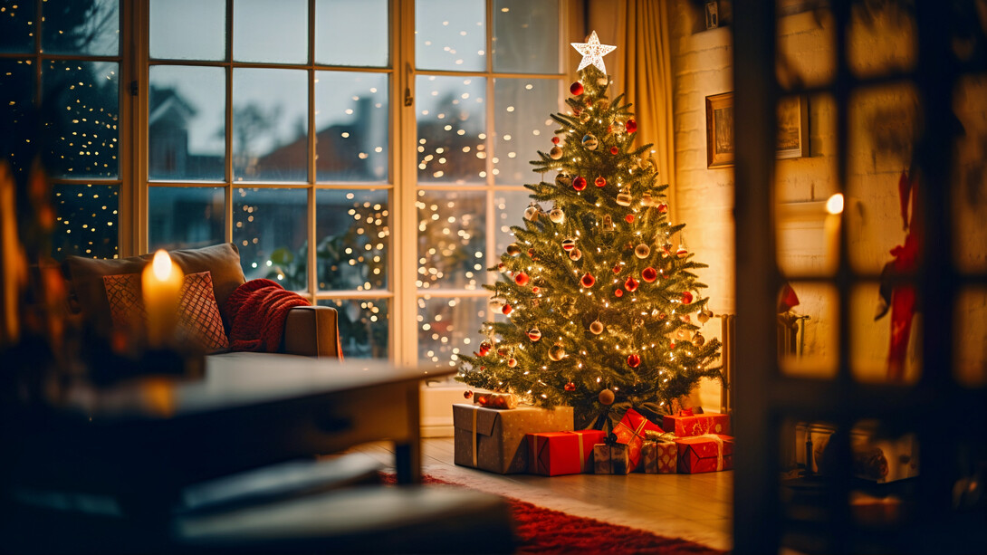 A beautifully lit Christmas tree glowing inside a home, representing the warmth and togetherness that defines Christmas across cultures
