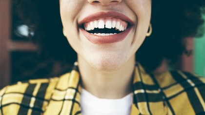 A happy woman smiling with healthy teeth