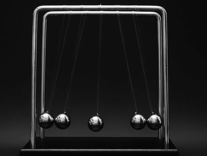 This iconic desk toy serves as a visual representation of Newton's third law, where the equal and opposite reactions of the spheres create a mesmerizing display of energy transfer