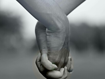 Couple grips hands together tightly