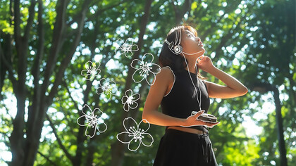 A woman posing outdoors, surrounded by nature, embodying the principles of personal growth and the Japanese philosophy of Oubaitori