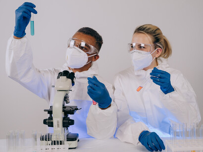 Two scientists doing research on various vials of liquid