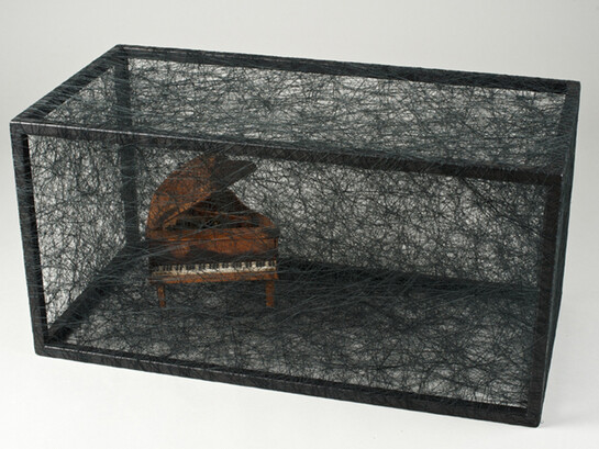 Chiharu Shiota, State of Being (Piano), 2014, metal, small piano and black thread, 30 x 60 x 30 cm - 11 3/4 x 23 5/8 x 11 3/42 in. Unique, © Sunhi Mang Courtesy Chiharu Shiota and Galerie Daniel Templon