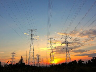 Electrical transmission towers carrying energy across vast distances, symbolising the growing cyber risks facing national power grids