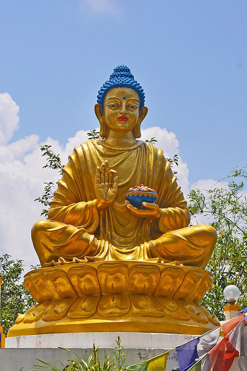 Buddha statue at Deola hills Kalimpong India This is a statue of Golden Buddha in Abhaya ( Protection ) Mudra, raised right hand with pot in the left hand, India