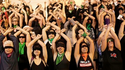 Women standing together in their cause to combat femicide in Latin America