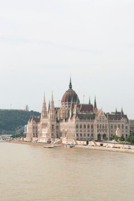 The Hungarian Parliament Building in Budapest, Hungary, an architectural marvel completed in 1904, showcases a stunning fusion of Gothic Revival, Baroque, and Renaissance Revival styles, making it a centrepiece of the city's rich heritage