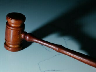 The officer acts friendly and criticizes the regime to gain the woman's trust