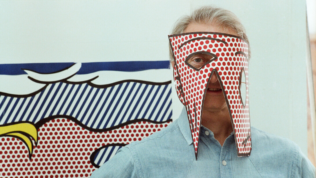 Roy Lichtenstein wearing a mask cut out from
one of his proofs for the Paintings Series (detail), 1983, Sidney B. Felsen (American, b. 1924)
Archival inkjet print from negative
Getty Research Institute, Los Angeles, 2019.R.41.  
Gift of Jack Shear. Art © Estate of Roy Lichtenstein.  
Photo © J. Paul Getty Trust