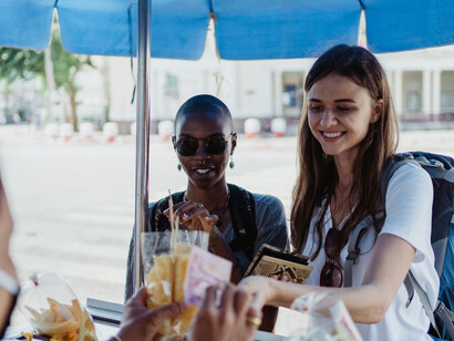 Women buying street food at a market in Asia