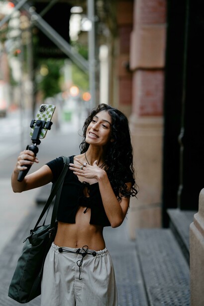 Smiling woman taking a selfie, a travel blogger capturing content for her vlog