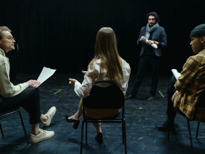 People holding scripts of the play as they prepare for the theatre