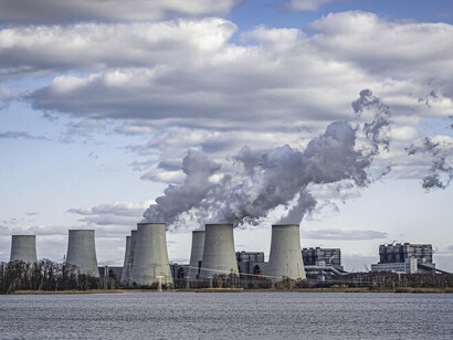A plume of white smoke rises from the cooling towers of the nuclear power plants