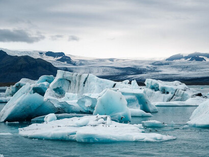 A clear daytime image of icebergs and glaciers melting, depicting the consequences of global warming