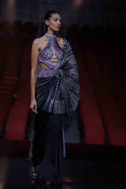 Modelo usa vestido em tons escuros com detalhe na manga