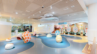 Interior of a modern pediatric ward with colorful seating, designed to create a welcoming and family-friendly environment for young patients