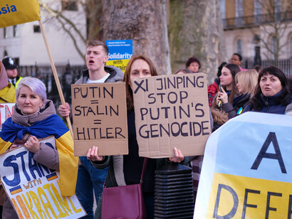 The demonstration against the war in Ukraine calls for a re-evaluation of our priorities, urging that we address human-centric issues like poverty and clean water instead of investing in destructive military technologies