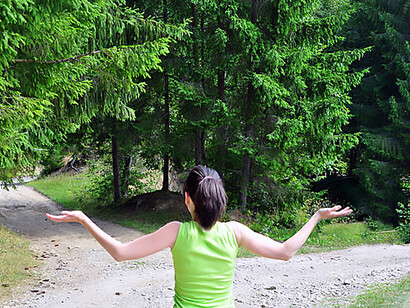 A girl standing at a fork in the road, facing a choice