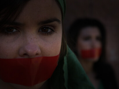 Women with tape on their mouths. Many rules and regulations are there which cannot be criticized due to such self-censorship