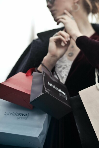 A woman carrying lots of bags after a shopping spree