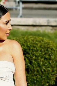 Kim Kardashian and Kanye West in a garden having a minor disagreement