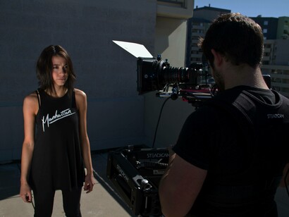 An actress is being filmed by a male cameraman which marks the significant disparity in the modern era's gender casting and hiring choices 