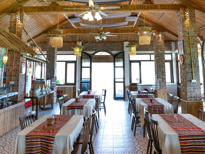 Woven bamboo light fixtures hang from the ceiling, adding to the warm, natural atmosphere