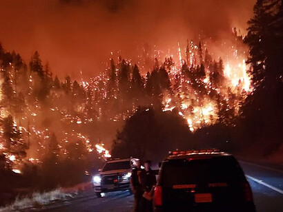 An image captured during the early stages of the Eaton Fire response, showing USFS Engine personnel actively engaged in the initial attack to combat the blaze in Los Angeles, USA