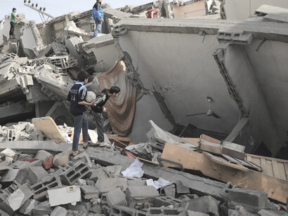 Among the ruins of Gaza's bombed buildings, people stand resilient, confronting the aftermath of destruction, Palestine