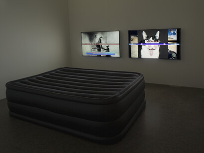 Clunie Reid, In Pursuit of the Liquid, 2013, Two screen HD videos on 50” flat-screen monitors, inflatable mattress, Courtesy the artist and MOT International
