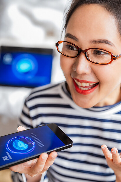 With a close-up of her hand on the screen, the smiling woman interacts with an AI assistant that interprets visual data and provides guidance, reflecting the ease of integrating intelligent systems into everyday lif
