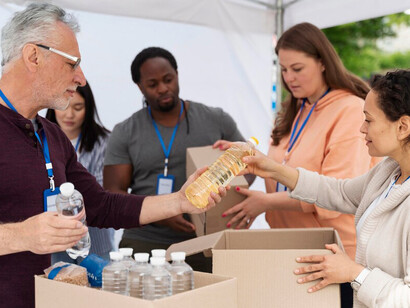 A group of volunteers helping at a food bank, spreading kindness and creating a ripple effect of generosity