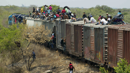 Immigrants ride on top of a Northern bound train toward the US-Mexico border