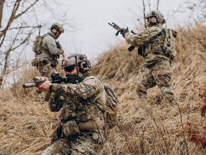 Private military contractors engaged in combat, heavily armed and operating as security forces